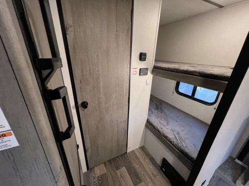 Interior Bunk Beds, Fridge, and entry to bathroom
